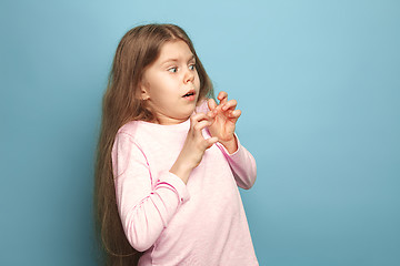 Image showing The fear. Teen girl on a blue background. Facial expressions and people emotions concept