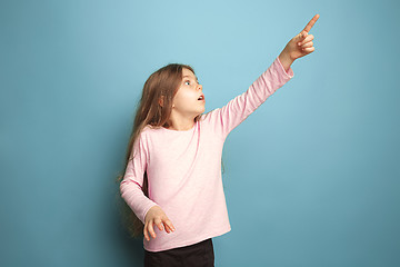 Image showing The determination. Teen girl on a blue background. Facial expressions and people emotions concept