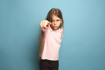 Image showing The determination. Teen girl on a blue background. Facial expressions and people emotions concept