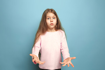 Image showing The surprise. Teen girl on a blue background. Facial expressions and people emotions concept