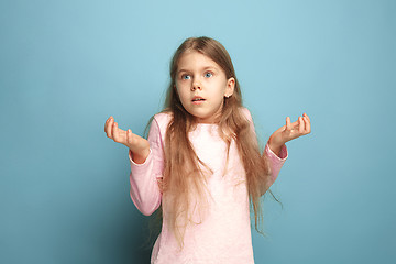 Image showing The surprise. Teen girl on a blue background. Facial expressions and people emotions concept