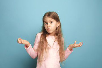 Image showing The surprise. Teen girl on a blue background. Facial expressions and people emotions concept