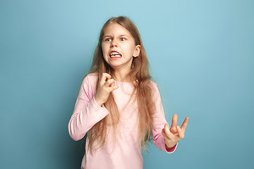 Image showing The hate. Teen girl on a blue background. Facial expressions and people emotions concept