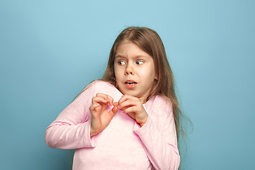 Image showing The fear. Teen girl on a blue background. Facial expressions and people emotions concept