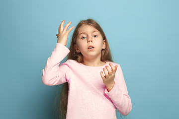 Image showing The deplorable girl. Teen girl on a blue background. Facial expressions and people emotions concept