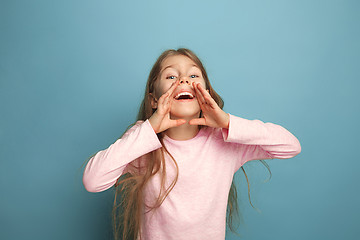 Image showing The emotional blonde teen girl have a happiness look and screaming. Studio shot