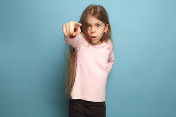 Image showing The determination. Teen girl on a blue background. Facial expressions and people emotions concept