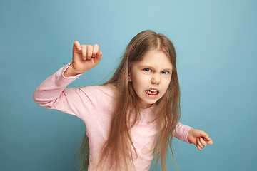 Image showing The hate. Teen girl on a blue background. Facial expressions and people emotions concept