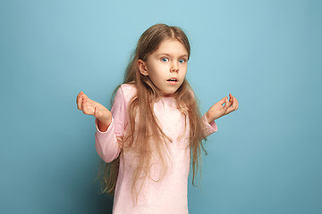 Image showing The surprise. Teen girl on a blue background. Facial expressions and people emotions concept