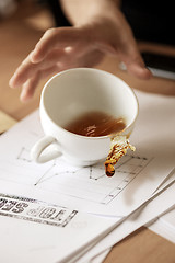 Image showing Coffee in white cup spilling on the table in the morning working day at office table