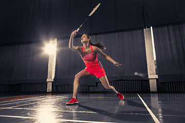 Image showing Young woman playing badminton at gym