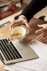 Image showing Coffee in white cup spilling on the table in the morning working day at office table