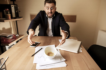 Image showing Coffee in white cup spilling on the table in the morning working day at office table