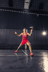 Image showing Young woman playing badminton at gym