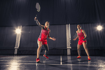 Image showing Young women playing badminton at gym