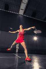 Image showing Young woman playing badminton at gym