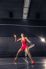 Image showing Young woman playing badminton at gym