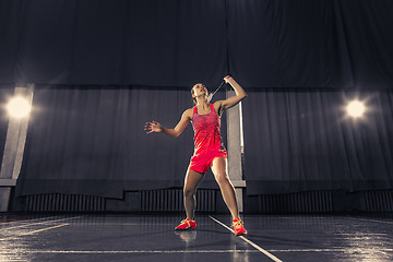 Image showing Young woman playing badminton at gym