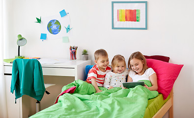 Image showing little kids with tablet pc in bed at home