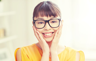 Image showing happy asian young woman in glasses at home