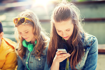 Image showing happy teenage friends with smartphones outdoors