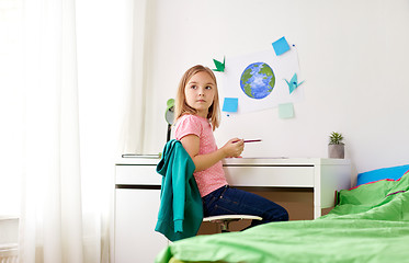 Image showing little girl doing homework or drawing at home