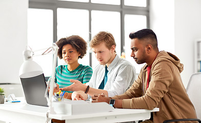 Image showing happy creative workers with laptops at office