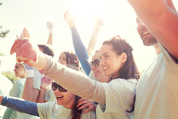 Image showing group of volunteers celebrating success in park