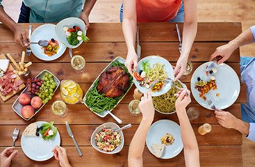 Image showing group of people eating at table with food