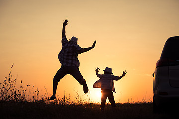 Image showing Father and son playing in the park at the sunset time.