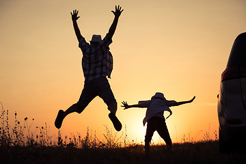 Image showing Father and son playing in the park at the sunset time.