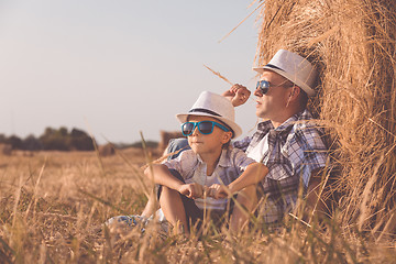 Image showing Father and son playing in the park at the day time.