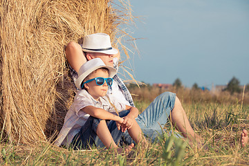 Image showing Father and son playing in the park at the day time.