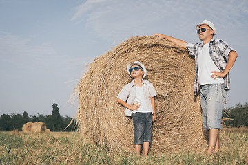 Image showing Father and son playing in the park at the day time.