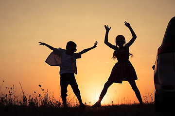 Image showing Happy children playing in the park at the sunset time.