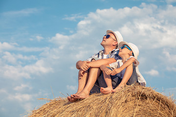 Image showing Father and son playing in the park at the day time.