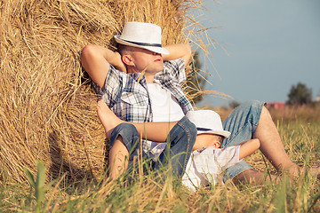 Image showing Father and son playing in the park at the day time.