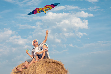 Image showing Father and son playing in the park at the day time.