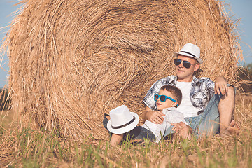 Image showing Father and son playing in the park at the day time.