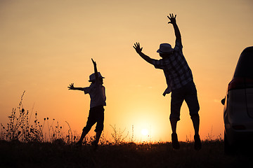 Image showing Father and son playing in the park at the sunset time.