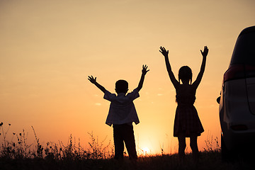 Image showing Happy children playing in the park at the sunset time.