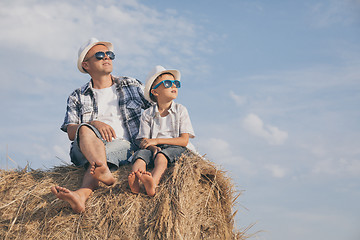 Image showing Father and son playing in the park at the day time.