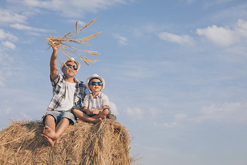 Image showing Father and son playing in the park at the day time.