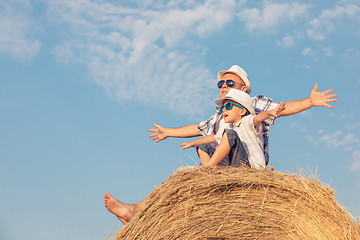 Image showing Father and son playing in the park at the day time.