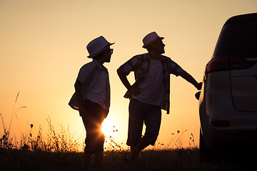 Image showing Father and son playing in the park at the sunset time.