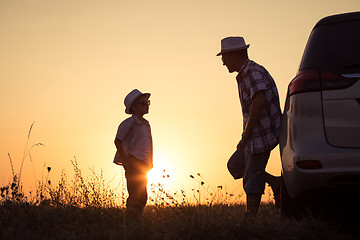 Image showing Father and son playing in the park at the sunset time.