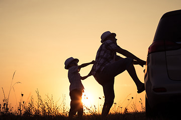 Image showing Father and son playing in the park at the sunset time.