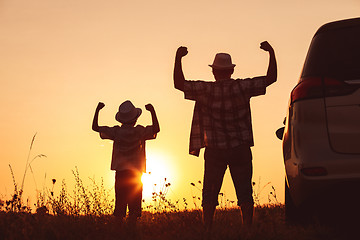 Image showing Father and son playing in the park at the sunset time.