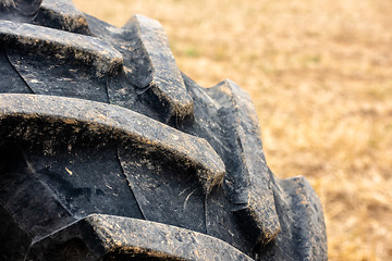 Image showing Wheels of tractor plowing field