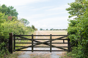 Image showing Old gate by a country road